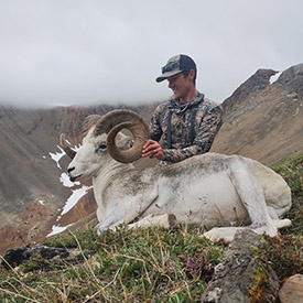 Hunter holding a Stone's sheep